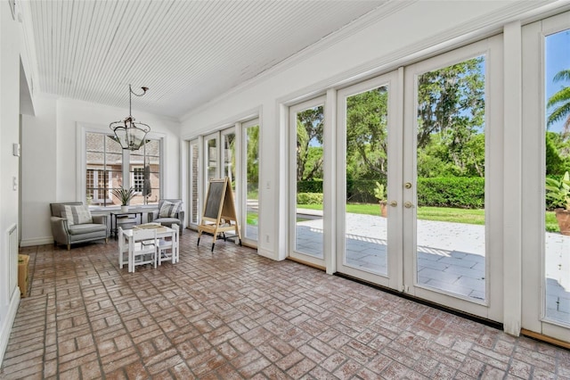 16502 Millan De Avila, Tampa, FL 33613 - unfurnished sunroom featuring french doors and a chandelier