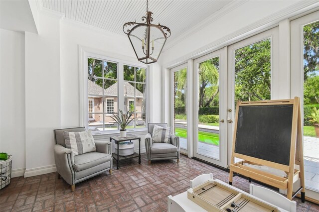 16502 Millan De Avila, Tampa, FL 33613 - sunroom / solarium with french doors, a chandelier, and plenty of natural light
