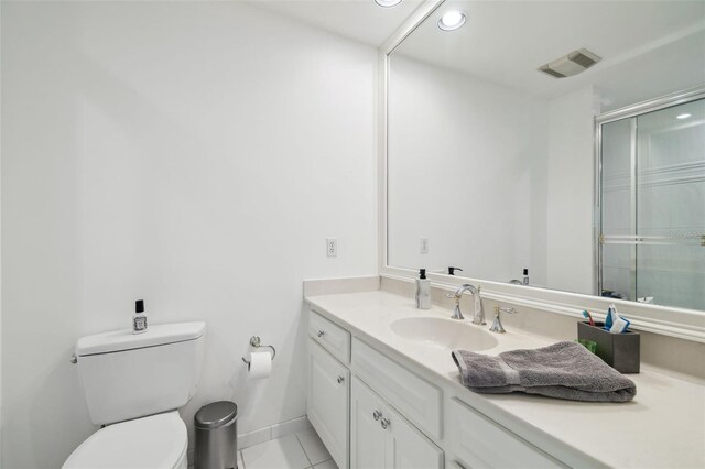 16502 Millan De Avila, Tampa, FL 33613 - bathroom with vanity, toilet, recessed lighting, tile patterned floors, and an enclosed shower