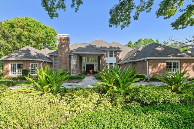 16502 Millan De Avila, Tampa, FL 33613 - rear view of house featuring brick siding and a chimney