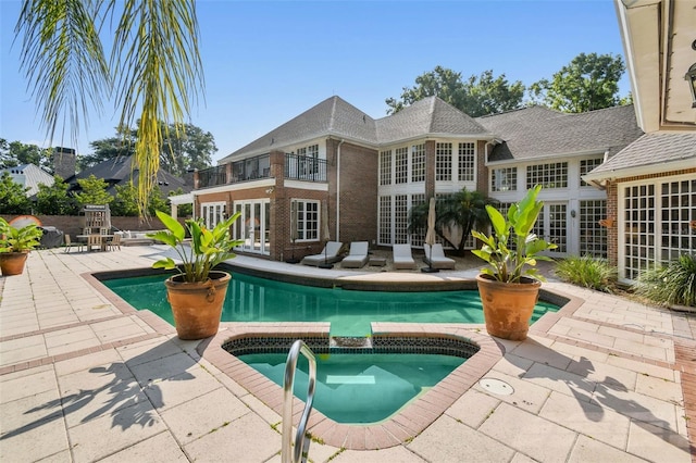 16502 Millan De Avila, Tampa, FL 33613 - outdoor pool with an in-ground hot tub, a patio area, and french doors