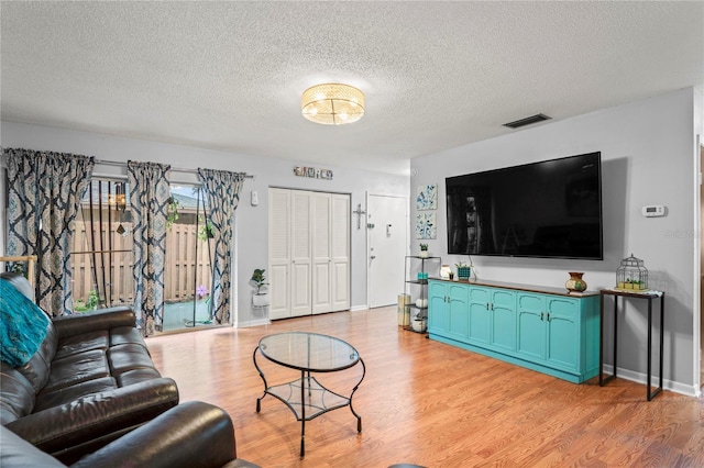 802 Antler Ct, Brandon, FL 33511 - living area featuring light wood-type flooring and a textured ceiling