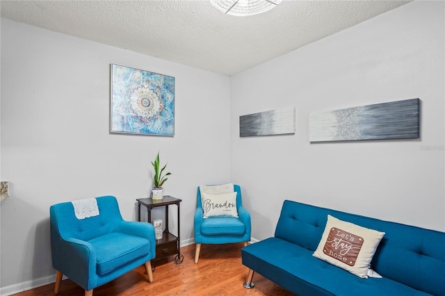 802 Antler Ct, Brandon, FL 33511 - sitting room with wood finished floors, a textured ceiling, and baseboards