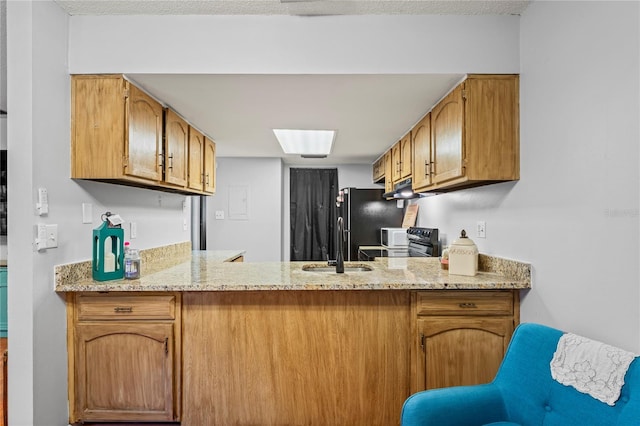 802 Antler Ct, Brandon, FL 33511 - kitchen featuring a peninsula, brown cabinetry, a sink, and stove