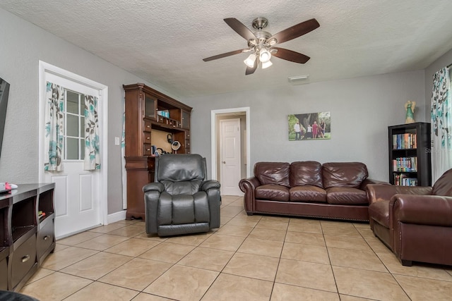 1403 W Pradera Ave, Tampa, FL 33612 - living room featuring light tile patterned floors, ceiling fan, and a textured ceiling