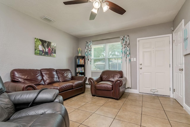 1403 W Pradera Ave, Tampa, FL 33612 - living area featuring light tile patterned flooring, a ceiling fan, and baseboards