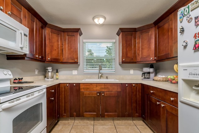 1403 W Pradera Ave, Tampa, FL 33612 - kitchen with white appliances, a sink, light countertops, and light tile patterned floors