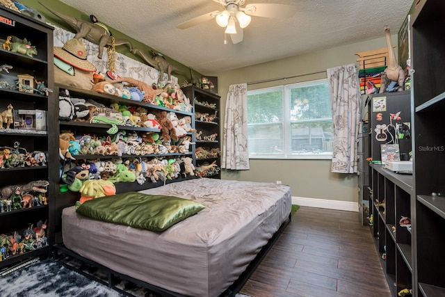 1403 W Pradera Ave, Tampa, FL 33612 - bedroom featuring baseboards, a textured ceiling, wood finished floors, and ceiling fan