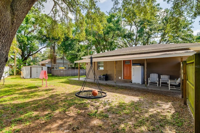 1403 W Pradera Ave, Tampa, FL 33612 - back of house with a patio area and roof with shingles