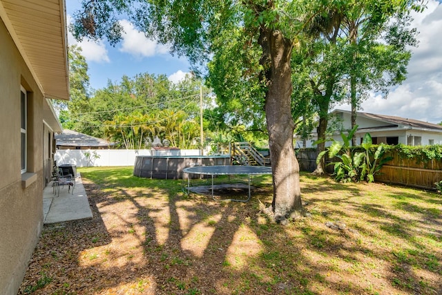 1403 W Pradera Ave, Tampa, FL 33612 - view of yard with a trampoline