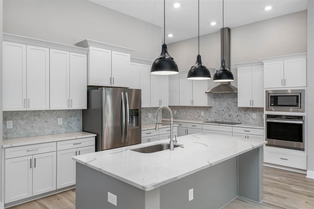 17404 Nokota Ave, Hudson, FL 34667 - kitchen with appliances with stainless steel finishes, a sink, white cabinets, a center island with sink, and recessed lighting