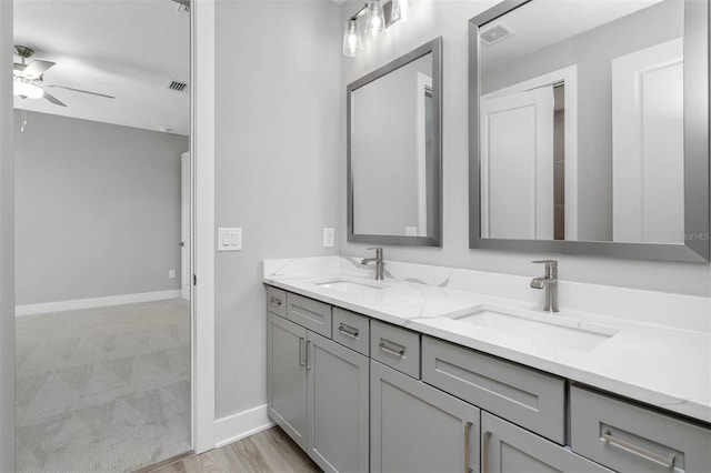 17404 Nokota Ave, Hudson, FL 34667 - bathroom with ceiling fan, double vanity, and baseboards