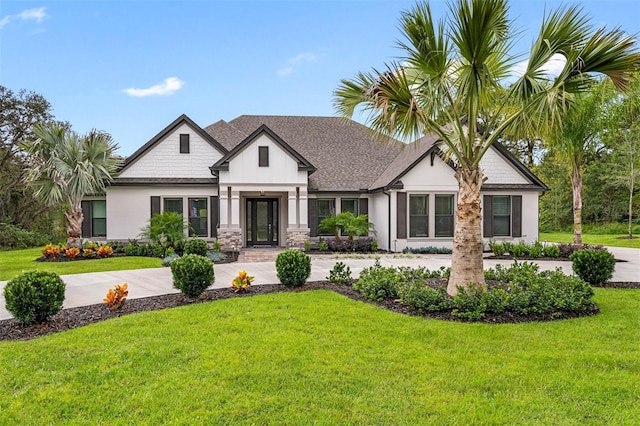 13167 Oldenburg Dr, Hudson, FL 34667 - view of front of house featuring a front yard, stone siding, and stucco siding