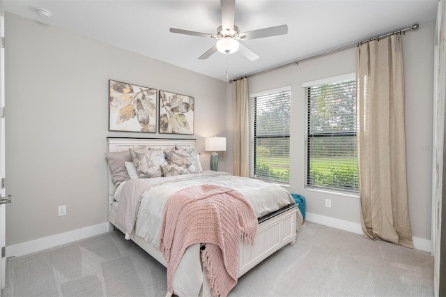13167 Oldenburg Dr, Hudson, FL 34667 - bedroom featuring light carpet, baseboards, and a ceiling fan