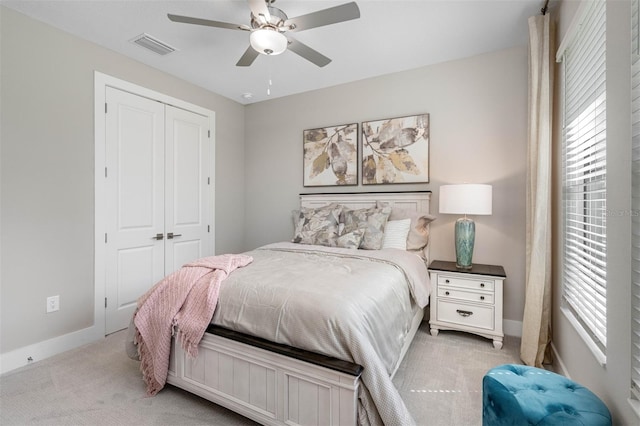 13167 Oldenburg Dr, Hudson, FL 34667 - bedroom featuring light carpet, baseboards, a closet, and ceiling fan