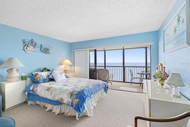 14950 Gulf Blvd Unit 905, Madeira Beach, FL 33708 - bedroom with a water view, access to outside, carpet flooring, and a textured ceiling