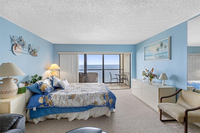 14950 Gulf Blvd Unit 905, Madeira Beach, FL 33708 - carpeted bedroom with a textured ceiling and a water view