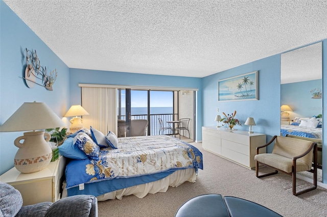 14950 Gulf Blvd Unit 905, Madeira Beach, FL 33708 - carpeted bedroom with a textured ceiling, access to outside, and a water view
