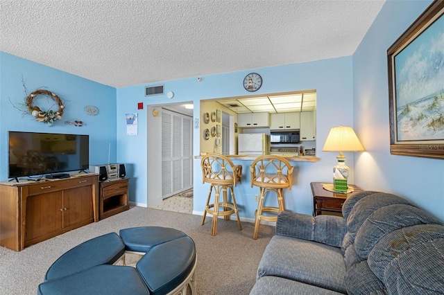 14950 Gulf Blvd Unit 905, Madeira Beach, FL 33708 - living area with carpet floors, a textured ceiling, and baseboards
