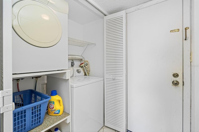 14950 Gulf Blvd Unit 905, Madeira Beach, FL 33708 - laundry room with estacked washer and dryer and a textured ceiling