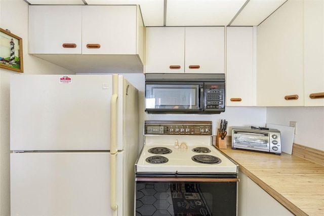 14950 Gulf Blvd Unit 905, Madeira Beach, FL 33708 - kitchen featuring freestanding refrigerator, black microwave, range with electric cooktop, white cabinetry, and butcher block countertops