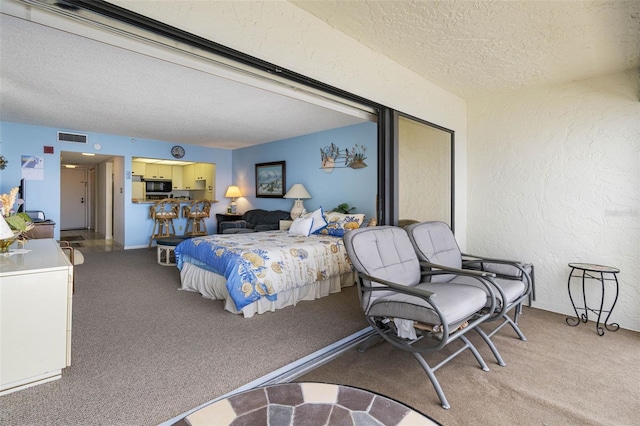 14950 Gulf Blvd Unit 905, Madeira Beach, FL 33708 - bedroom with a textured ceiling, light carpet, and a textured wall