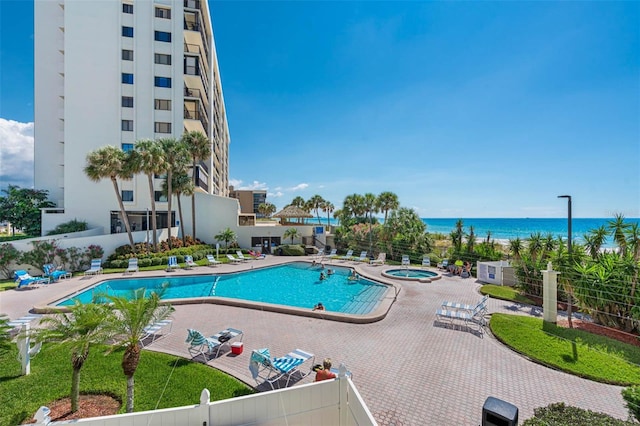 14950 Gulf Blvd Unit 905, Madeira Beach, FL 33708 - community pool featuring a community hot tub, a water view, and a patio
