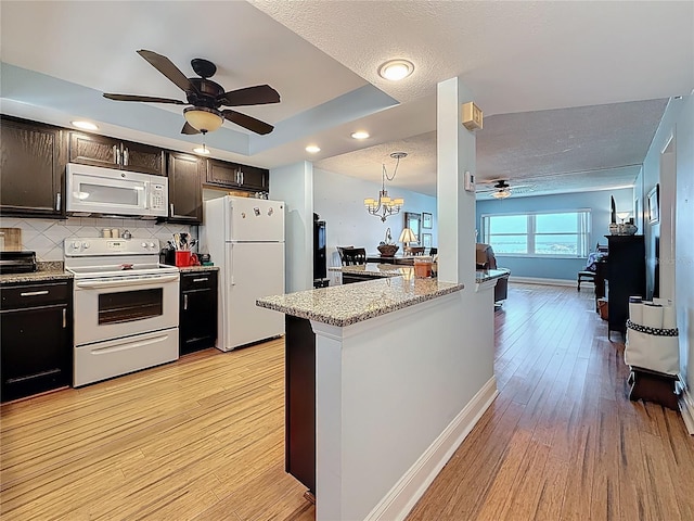 4725 Cove Cir Unit 908, Saint Petersburg, FL 33708 - kitchen featuring white appliances, a ceiling fan, light wood-style floors, backsplash, and a textured ceiling