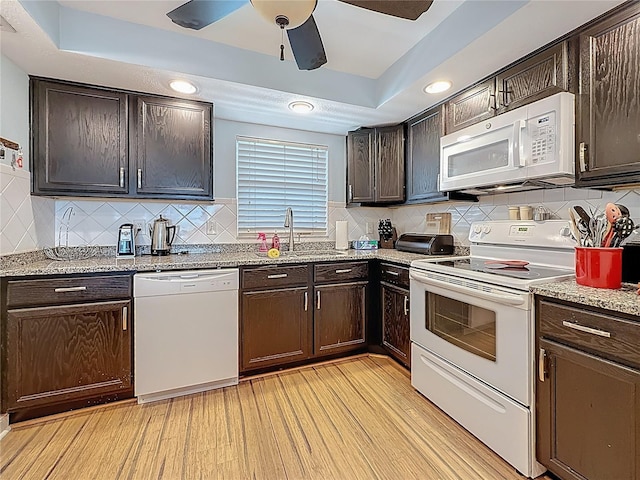 4725 Cove Cir Unit 908, Saint Petersburg, FL 33708 - kitchen featuring white appliances, a sink, dark brown cabinets, and recessed lighting