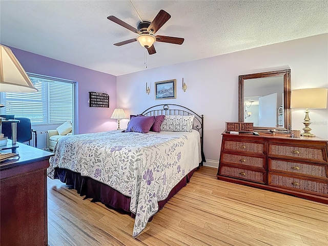 4725 Cove Cir Unit 908, Saint Petersburg, FL 33708 - bedroom with light wood-style flooring, ceiling fan, and a textured ceiling