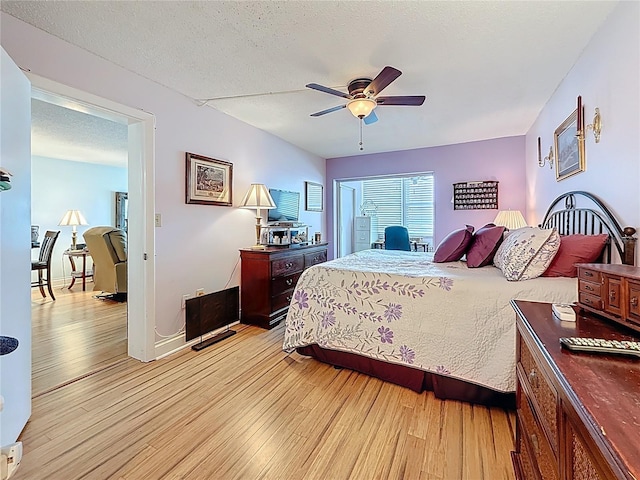 4725 Cove Cir Unit 908, Saint Petersburg, FL 33708 - bedroom with light wood-style floors, a ceiling fan, and a textured ceiling