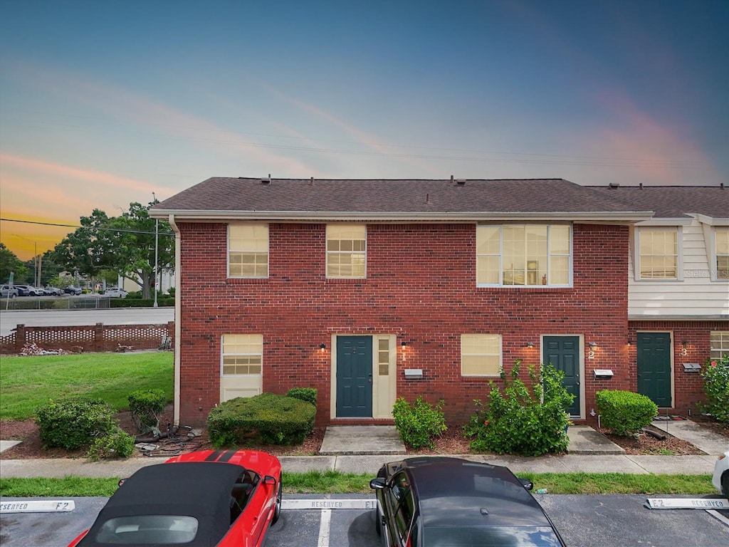 1920 E Edgewood Dr Unit E1, Lakeland, FL 33803 - townhome / multi-family property featuring uncovered parking and brick siding