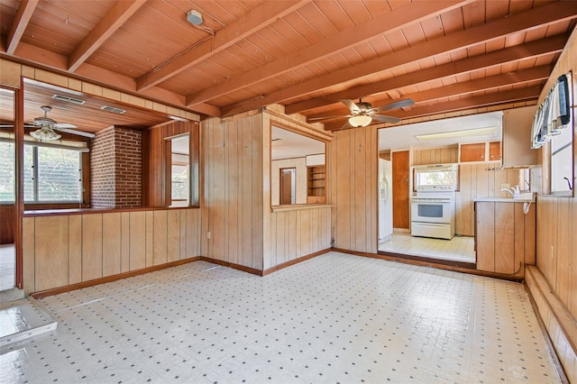 601 75th St N, Saint Petersburg, FL 33710 - empty room featuring a ceiling fan, wooden walls, wooden ceiling with exposed beams, and baseboards