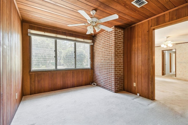 601 75th St N, Saint Petersburg, FL 33710 - carpeted spare room with wooden ceiling, plenty of natural light, a ceiling fan, and wood walls