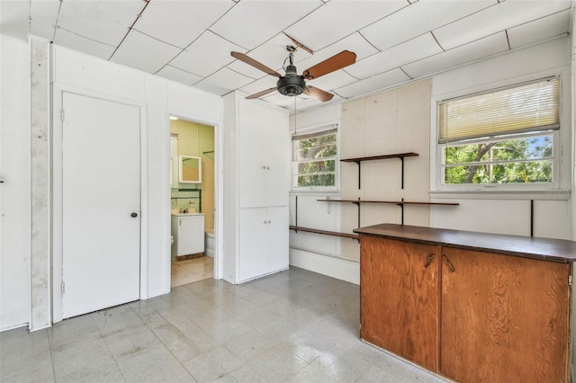 601 75th St N, Saint Petersburg, FL 33710 - kitchen featuring a ceiling fan and dark countertops