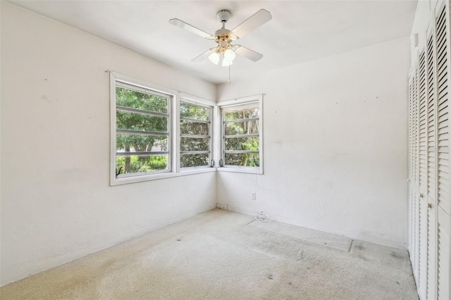 601 75th St N, Saint Petersburg, FL 33710 - unfurnished bedroom with carpet flooring, a closet, and a ceiling fan
