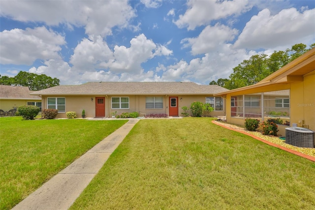 1904 Canterbury Ln Unit 18, Sun City Center, FL 33573 - single story home featuring cooling unit, a front lawn, and stucco siding