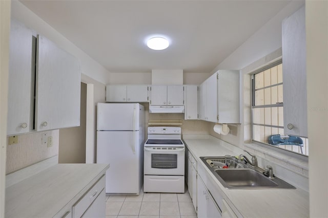 1904 Canterbury Ln Unit 18, Sun City Center, FL 33573 - kitchen with white appliances, a sink, under cabinet range hood, light countertops, and white cabinetry