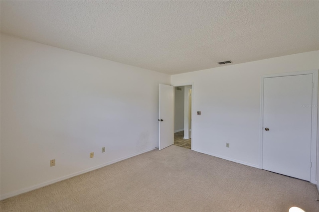 1904 Canterbury Ln Unit 18, Sun City Center, FL 33573 - unfurnished bedroom featuring light colored carpet, a textured ceiling, and baseboards