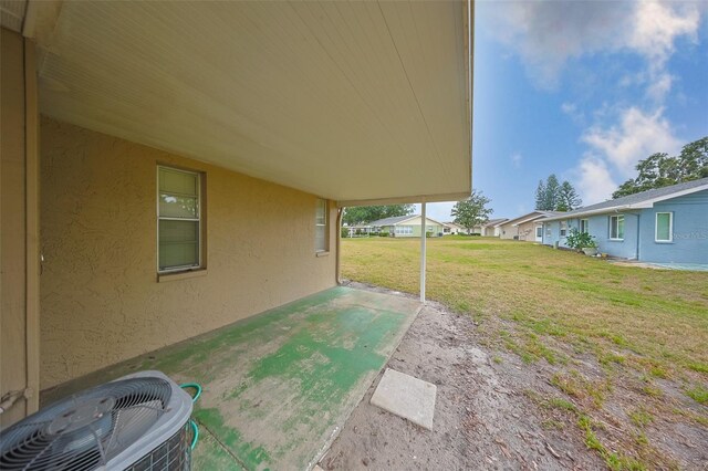 1904 Canterbury Ln Unit 18, Sun City Center, FL 33573 - view of grassy yard featuring central AC and a patio