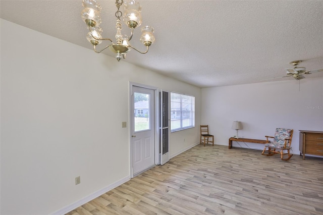 1904 Canterbury Ln Unit 18, Sun City Center, FL 33573 - foyer with light wood-type flooring, a textured ceiling, a chandelier, and baseboards