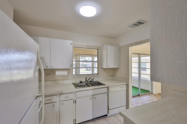 1904 Canterbury Ln Unit 18, Sun City Center, FL 33573 - kitchen featuring white appliances, a sink, light countertops, white cabinetry, and light tile patterned flooring