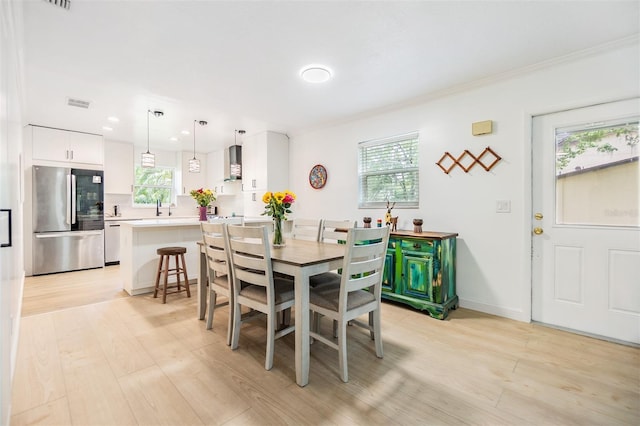1400 Tarpon Woods Blvd Unit E4, Palm Harbor, FL 34685 - dining space with healthy amount of natural light, light wood finished floors, ornamental molding, and recessed lighting