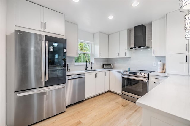 1400 Tarpon Woods Blvd Unit E4, Palm Harbor, FL 34685 - kitchen with stainless steel appliances, wall chimney range hood, a sink, light countertops, and recessed lighting