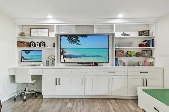 10387 Majestic Dr, Largo, FL 33774 - home office with light wood-style floors, recessed lighting, and built in desk