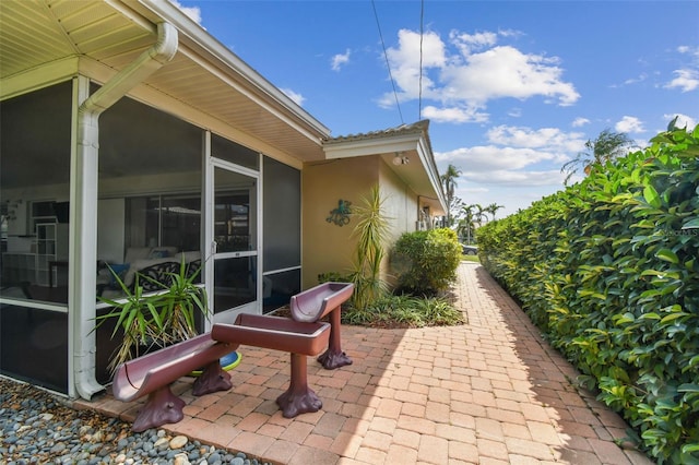 10387 Majestic Dr, Largo, FL 33774 - view of patio featuring a sunroom
