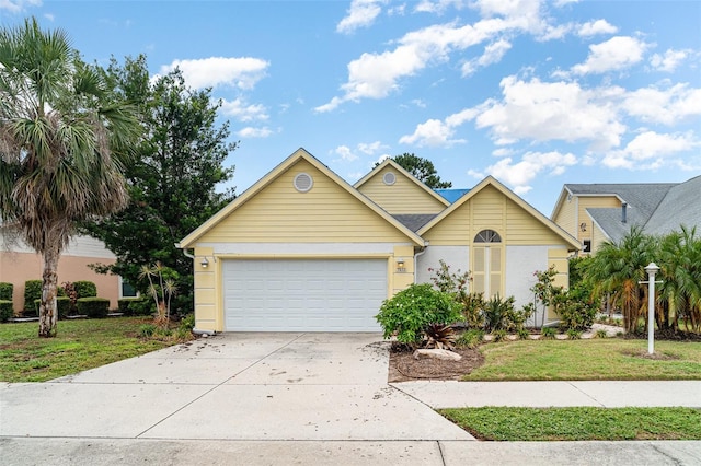 7833 Ontario Street Cir, Sarasota, FL 34243 - view of front facade featuring driveway, a garage, and a front yard