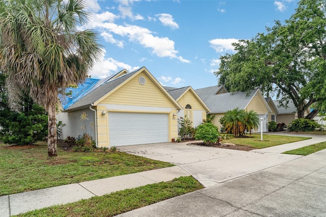 7833 Ontario Street Cir, Sarasota, FL 34243 - view of front of property featuring driveway, a garage, a front lawn, and stucco siding