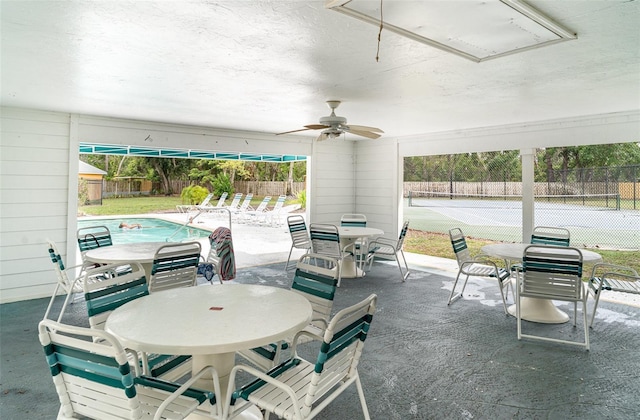 7833 Ontario Street Cir, Sarasota, FL 34243 - fenced backyard with outdoor dining space, a ceiling fan, and a patio area