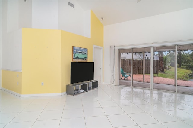 7833 Ontario Street Cir, Sarasota, FL 34243 - unfurnished living room with a high ceiling, baseboards, and tile patterned flooring